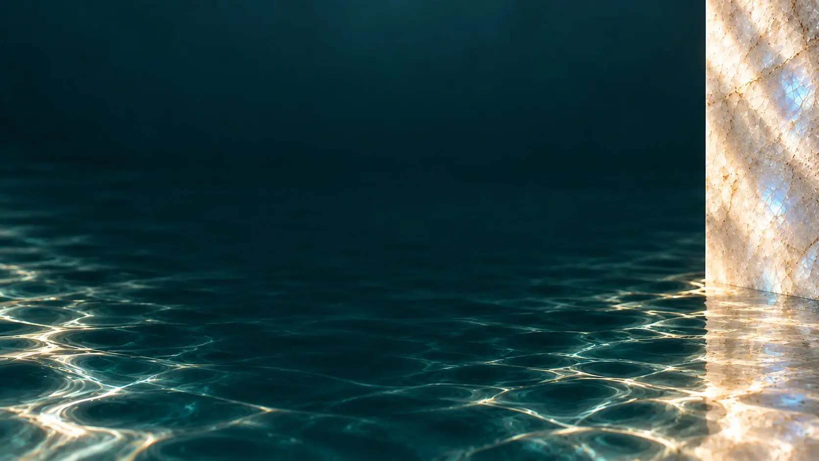 Light rippling across clear teal water